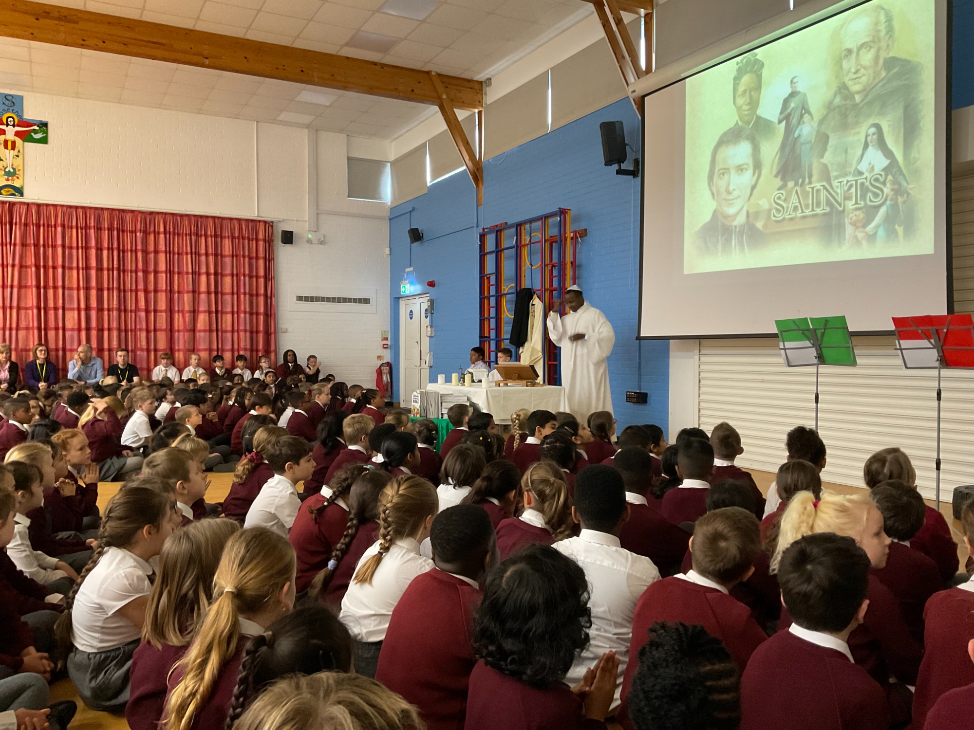 Children attending mass in the school hall